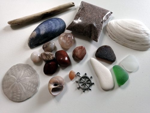 Sand, sea glass, stone, drift wood, shell